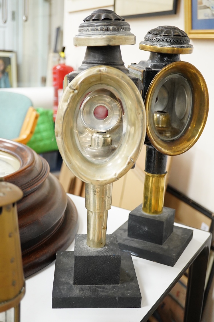 Two 19th century brass and painted steel carriage lamps, one by Raydyot with sprung ‘self adjusting’ candle holders, now mounted on modern painted pine bases for display purposes
